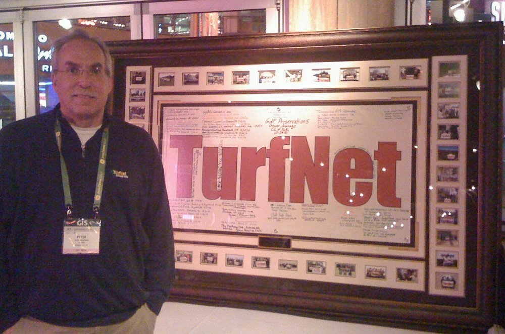TurfNet founder Peter McCormick with the 'Where's TurfNet?' banner at the 2011 GIS in Orlando.