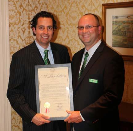 Kirtland Country Club president Brian Zollar (left) presents Chad Mark with a framed copy of the resolution read before the Ohio State Senate earlier this year by Sen. John Eklund.