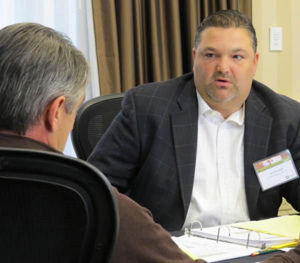 Jim Pavonetti, CGCS, (right) strikes his best deal with John Cunningham, CGCS, during a negotiating exercise at this year's Syngenta Business Institute.